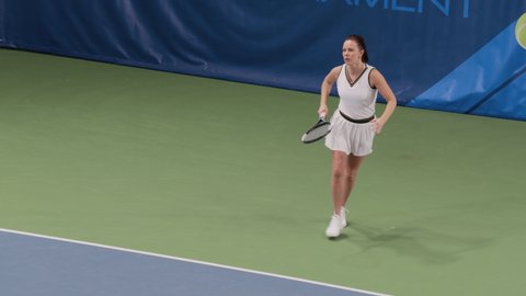 Female Tennis Player Strikes Ball with Racquet, Wins Championship Match. Professional Woman Athlete Celebrates Victory after Perfect Shot. World Sports Tournament TV Channel Playback. Slow Motion