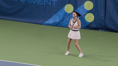 Tennis Championship Match: Female Player Strikes Ball with Racquet, Finishes Set. Professional Woman Athlete Walks after Perfect Shot. World Sports Tournament TV Channel Playback. Slow Motion