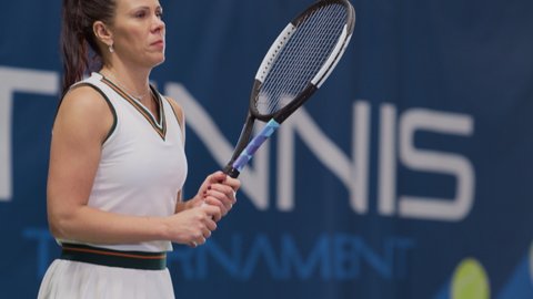 Female Tennis Player Holding the Racquet During Championship Match, Jumping Warmup, Ready to Receive Ball Strike. Professional Woman Athlete. Sports Broadcasting on TV Channel. Slow Motion Medium