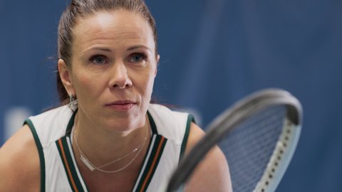 Potrait of Female Tennis Player Holding the Racquet During Championship Match, Ready for Receive Ball Strike. Charismatic Professional Woman Athlete. Sports Broadcasting on TV Channel. Focus on Face