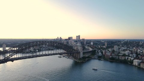 Aerial drone view of Sydney Harbour Bridge in the late afternoon heading toward North Sydney      