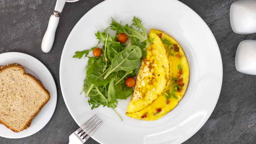 Rotating a Cheese Omelette and Salad with Tomatoes