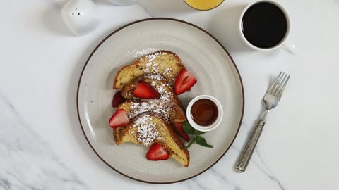 Serving a Plate of French Toast with Strawberries
