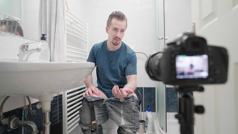 Male influencer in bathroom on toilet recording video talking about shit 4K