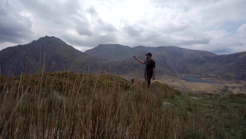 A photographer in the mountains talking about filming the landscape