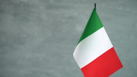State flag of Italian Republic waving on gray background. Italy flag and place for text