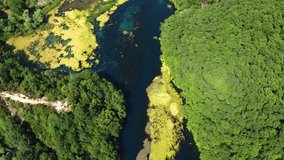 Drone shot of the Blue Eye in Albania - drone is following the river flow, showing its beautiful color and the clear water. Snippet could ideally be used for travel related videos or nature movies.