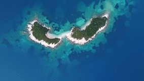 Drone shot of islands in the Mediterranean sea - drone is flying over beautiful islands and a speed boat near Ksamil, Albania. Snippet could ideally be used for travel related videos or movies.