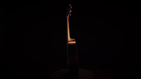 Ukulele on black background. Ukulele string instrument