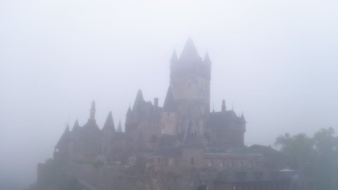 Aerial: Gothic Revival Style On Hill Top, Drone Flying Backwards During Foggy Weather - Cochem, Germany