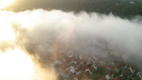 Aerial Lockdown Shit Of Clouds Moving Over Roofed Houses In Town During Sunrise - Heidelberg, Germany