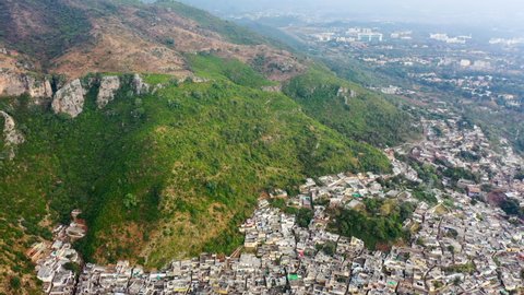 Aerial Circling Above Saidpur Village Surrounded By Steep Green Mountains - Islamabad, Pakistan