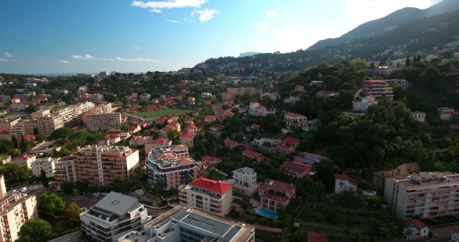 Aerial Upward Beautiful View Of Residential Town On Green Mountains - Monaco