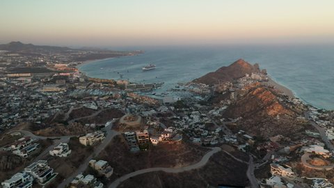 Drone shot of buildings on Playa El Médano with ocean in the distance in Cabo San Lucas Mexico, wide