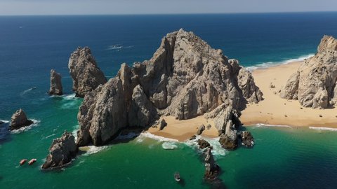 Drone shot of Playa del Amor and El Arco natural sea cliffs in Cabo San Lucas Mexico, wide and rotating
