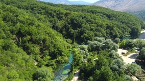 Drone shot of the Blue Eye in Albania - drone is ascending and panning down, revealing its beautiful colours and clear water. Snippet could ideally be used for travel related videos or nature movies.