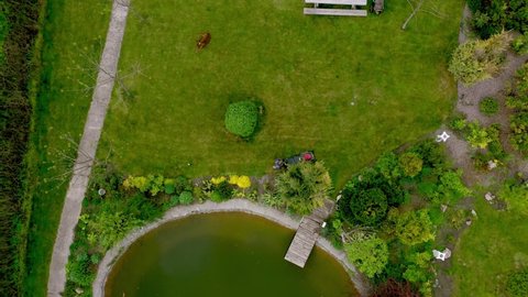 A man mows the lawn. Lawn mowing. Aerial view of the green grass. Professional landscape works. Lawn mower is a grass machine. Gardener's haircut care for working tools. Aerial lawn mowing
