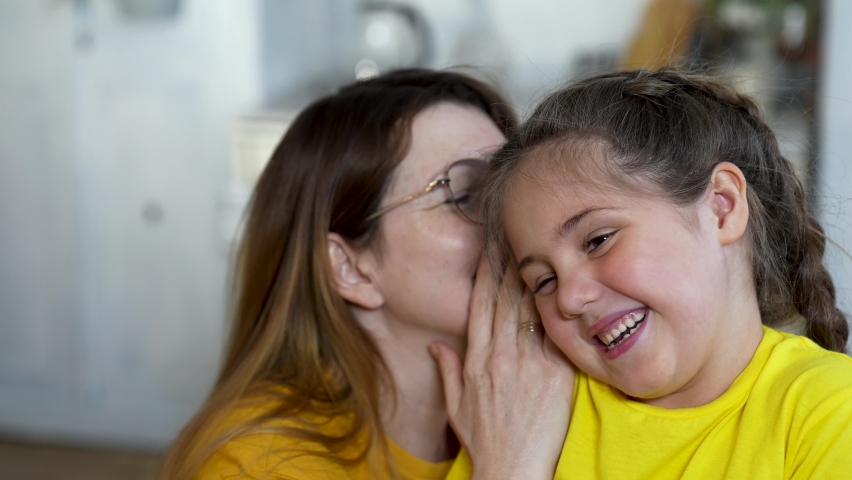 Daughters desire. Mother Whispering to daughter. Baby laughs adorably when mom Whispers in his Ears - 1089588.