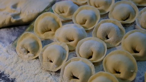 
Semi-finished dumplings.
Dough stuffed with meat. Traditional Russian cuisine dish. Flour product of high calorie content. Hand molding and a large number of products.
Concept: home cooking