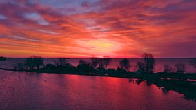 Twilight silhouettes of trees and homes amid swirling waters situated between wetlands and vast bay. I love the harmonious patterns in the clouds that seem to mimic the land forms below.
 - Powered by Shutterstock - Get 15% off with code: PIKWIZARD15