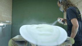 Surfboard manufacturing, Shaper paints a surfboard. Concept of surfing industry production, modern active lifestyle, skilled professional, millennial worker in America.  - Powered by Shutterstock - Get 15% off with code: PIKWIZARD15