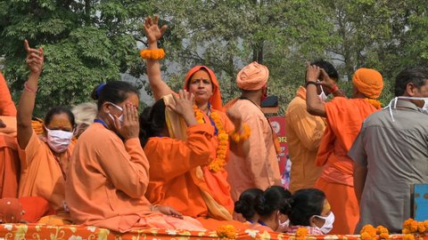 Haridwar, Uttarakhand, India - 15th April 2021 : Hindu female devotees going for shahi snaan on Kumbhmela, on decorated vehicles and shouting prayers for Lord Shiva.