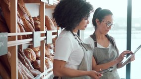 Video of couple women owners bakery working while analyzing report for order delivery with digital tablet in a pastry shop. - Powered by Shutterstock - Get 15% off with code: PIKWIZARD15