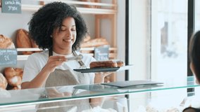 Video of smiling woman seller giving fresh biscuits to cheerful woman in the pastry shop. - Powered by Shutterstock - Get 15% off with code: PIKWIZARD15