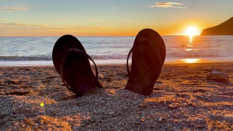 flip flop on the beach at sunset