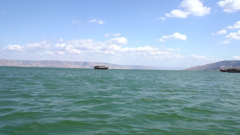 Sailing in the sea, apparently with the Golan Heights in the background