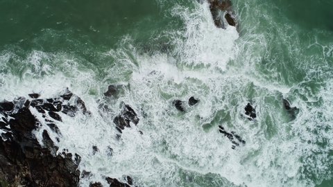 Aerial view of sea crashing waves White foaming waves on seashore rocks Top view fantastic Rocky coast Amazing nature background