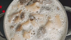 The cook is stirring morel mushrooms cooked in a saucepan with a wooden spoon - Powered by Shutterstock - Get 15% off with code: PIKWIZARD15