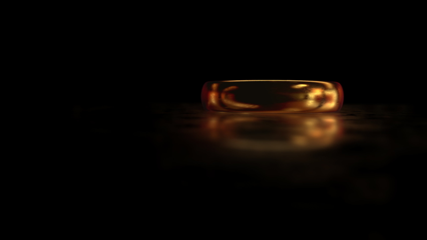 Flying around the gold ring THE LORD OF THE RINGS on the matte glass surface