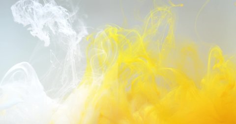 Yellow glitter ink spreading in water. Abstract colorful  background with white color. 4K.