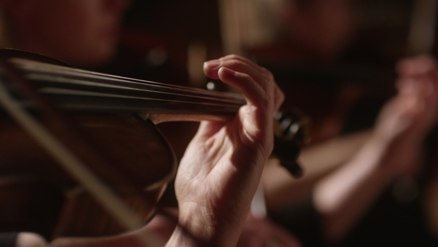 close-up person playing violin in orchestra (warm color correction) Royalty-Free Stock Footage #1090111661