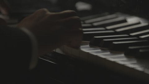 close-up on hand of a person playing piano