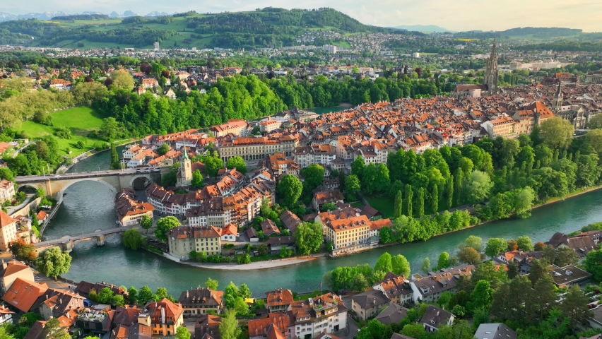 Bern aerial view, capital of Switzerland, tourism in Switzerland concept, drone view of Bern with bridges, historic towers and churches at sunset. 