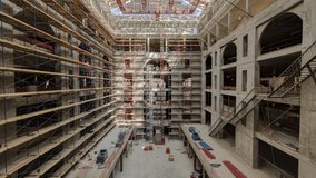 Panorama showing construction equipment material with scaffolding and tools inside the floor of high rising building timelapse, skyscraper. Building under construction. Interior work in progress. - Powered by Shutterstock - Get 15% off with code: PIKWIZARD15
