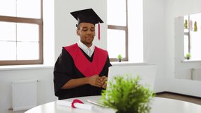 Virtual graduation ceremony. Black graduate in quarantine. The student covers his face with his hands in emotion after the broadcast