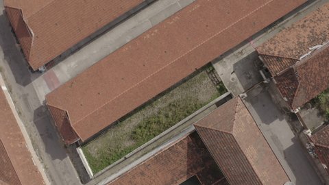 Aerial footage bird's eye view of symmetric roofs tilt up revealing busy avenue in Sao Paulo, Brazil