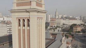 Aerial footage of clock tower at Luz station surrounded by buildings of downtown Sao Paulo, Brazil