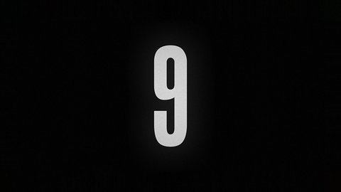 The number 9 burns and turns into ashes on a black background