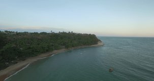 Aerial footage of beach with calm waters and vegetation close to the sea during sunset. Espelho beach, discovery coast, Bahia, Brazil