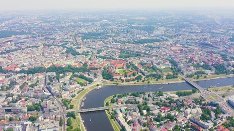 Inscription on video. Krakow, Poland. Wawel Castle. Ships on the Vistula River. View of the historic center. Different colors letters appears behind small squares, Aerial View, Departure of the camer