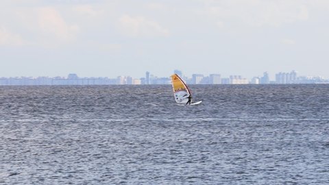 Gulf of Finland (near St. Petersburg), Russia, July 2021: Windsurfers surfing in the wind in summer. Competitions in windsurfing.