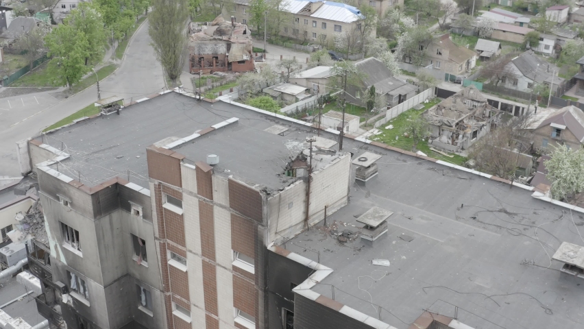 Damaged residential building in the Bucha city, Kyiv region during the fighting after the Russian attack on Ukraine. Russian-Ukrainian war. Aerial. Fire in the house. 