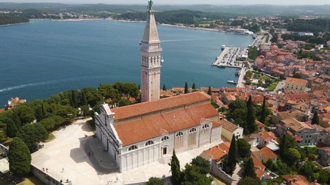 Aerial rotating shot over St. Euphemia church in Rovinj, Istria, Croatia with the view of the town in the background.
