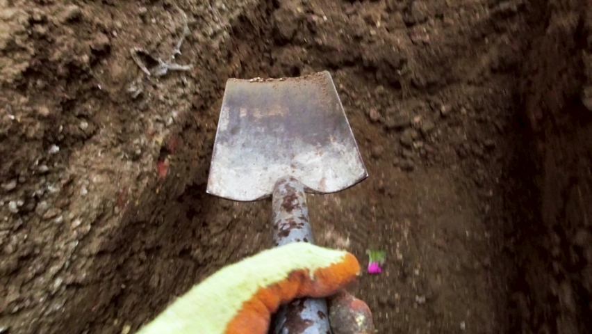 POV Spade Digging. Hand digging, clearing a trench 4K Royalty-Free Stock Footage #1090129891