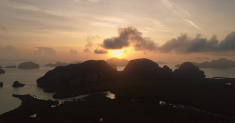 Silhouette of Phang Nga Bay island mountains during morning sunrise, aerial
