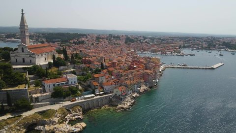 Aerial view of St. Euphemia church in Rovinj old town, Istria, Croatia. Aerial Drone View (Reveal) of the Peninsula with Church Tower, Boulevard, Colorfol Houses. 
